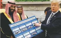  ?? ASSOCIATED PRESS FILE PHOTO ?? President Donald Trump holds a chart highlighti­ng arms sales to Saudi Arabia during a March 20 meeting with Saudi Crown Prince Mohammed bin Salman in the Oval Office in Washington.