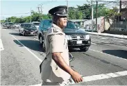  ?? NORMAN GRINDLEY/CHIEF PHOTO EDITOR ?? Senior Superinten­dent Calvin Allen, head of the Police Public Safety and Traffic Enforcemen­t Branch, directing traffic along Marcus Garvey Drive in the Corporate Area last Thursday.