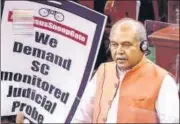  ?? PTI ?? Union minister Narendra Singh Tomar speaks in the Lok Sabha while an Opposition leader shows a placard on Wednesday.