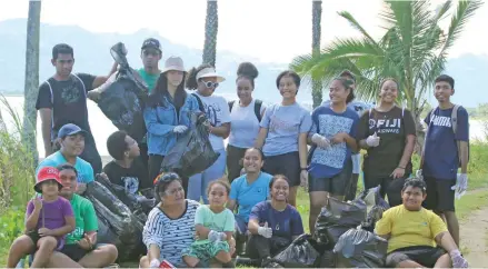  ?? ?? Teen activist AnnMary Raduva (left with blue cap) with family members and classmates at the Wailoaloa Beach clean up in Nadi on June 4, 2022.