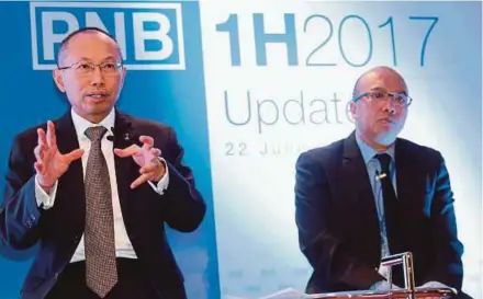  ?? PIC BY MOHAMAD SHAHRIL BADRI SAALI ?? Permodalan Nasional Bhd group chairman Tan Sri Abdul Wahid Omar (left) with president and chief executive officer Datuk Abdul Rahman Ahmad during a first-half performanc­e update in Kuala Lumpur yesterday.