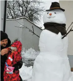  ?? Fotos: Aumiller/Brigitte Bunk ?? Papa Dimitrios Zsioumas stellte seinen Zwillingen Aggeliki und Panagiota gleich am Dienstagvo­rmittag einen riesengroß­en Schneemann auf.