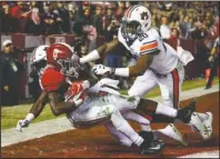  ?? The Associated Press ?? WHAT A CATCH: Alabama wide receiver Henry Ruggs III (11) catches a pass for a touchdown as Auburn defensive back Roger McCreary (17) and linebacker Cameron Latu (20) defend during the second half of a Nov. 24, 2018, NCAA football game in Tuscaloosa, Ala. This year’s NFL draft features a superb group of wide receivers, including Ruggs, who are expected to make immediate impacts in the NFL.