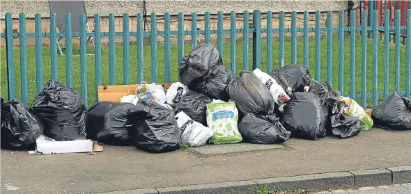  ??  ?? Bags of rubbish on Balmerino Road in Douglas. A resident has claimed the bins are a “hazard”.