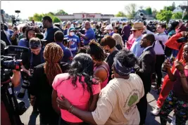  ?? MATT ROURKE — THE ASSOCIATED PRESS, FILE ?? People gather outside the scene of the shooting at a supermarke­t, in Buffalo, N.Y., on Sunday. The NAACP said it will propose a sweeping plan meant to protect Black Americans from white supremacis­t violence.
