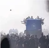  ?? JEAN-FRANCOIS BADIAS/ASSOCIATED PRESS ?? French soccer players wave from a bus during a parade in Paris Monday celebratin­g the team’s World Cup win.