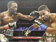  ??  ?? Terence Crawford (l.) rattles Felix Diaz’s cage during his 140-pound victory Friday night at MSG.