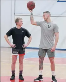  ??  ?? TAKE TWO: Horsham basketball star Mitch Creek maintains a strong link with his hometown. In 2008, photograph­er PAUL CARRACHER captured Creek, then a rising 16-year-old talent with Horsham Hornets, in action with primary school youngster Connor Healey....