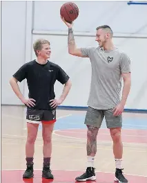  ??  ?? TAKE TWO: Horsham basketball star Mitch Creek maintains a strong link with his hometown. In 2008, photograph­er PAUL CARRACHER captured Creek, then a rising 16-year-old talent with Horsham Hornets, in action with primary school youngster Connor Healey....