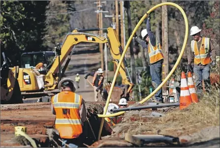  ?? Rich Pedroncell­i Associated Press ?? PG&E is taking heat from public officials and residents over its shut-offs last month. Above, power lines are buried in Paradise, Calif.