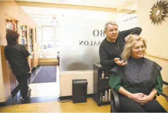  ?? Liz Hafalia / The Chronicle ?? Owner and stylist Bibbo Saab works on Kelly Cruz’s hair at at Bibbo Salon. Saab considered closing his salon when a mentally ill woman constantly terrorized clients.