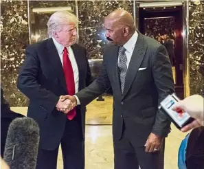  ?? — Bloomberg ?? Talking things over: Trump shaking hands with Harvey (right) during the meeting at the Trump Tower in New York.