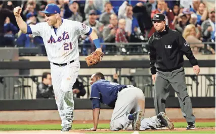  ?? ASSOCIATED PRESS ?? New York Mets third baseman Todd Frazier celebrates after tagging out the Brewers’ Lorenzo Cain at third base on a throw from leftfielde­r Yoenis Cespedes during the seventh inning.