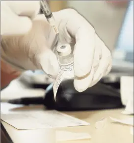  ?? Ned Gerard / Hearst Connecticu­t Media ?? A nurse fills a syringe with a dose of the Pfizer COVID-19 vaccine at Stamford Hospital last month.