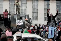  ?? PHOTO: REUTERS ?? Protesters calling for Zimbabwean President Robert Mugabe to step down take to the streets in Harare, Zimbabwe.