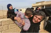  ?? Khalid Mohammed / Associated Press ?? Women and children leave their homes near Mosul as Iraqi forces bear down on ISIS militants.