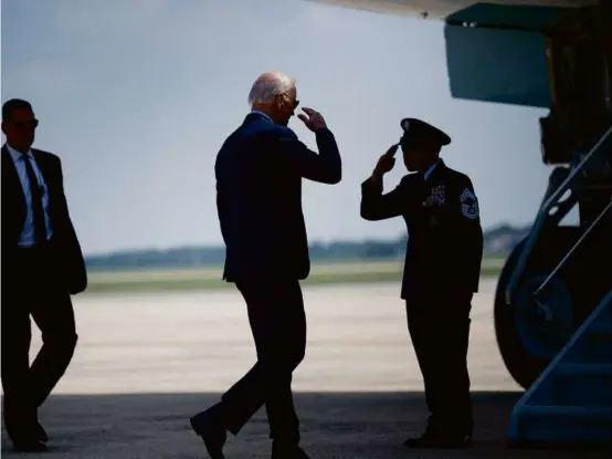  ?? BRENDAN SMIALOWSKI/AFP VIA GETTY IMAGES ?? President Biden boarded Air Force One at Joint Base Andrews. He had promised the overhaul during his campaign.