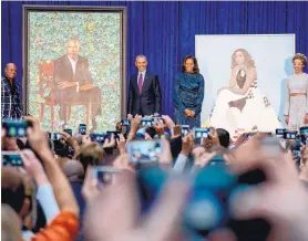  ?? ANDREW HARNIK/ASSOCIATED PRESS ?? Barack and Michelle Obama unveiled their portraits at the National Portrait Gallery on Monday. Artists Kehinde Wiley, left, and Amy Sherald are at left and right.