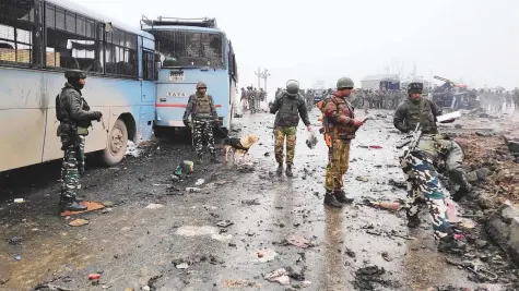  ?? Reuters ?? Soldiers examine the debris after an explosion in Lethpora in south Kashmir’s Pulwama district yesterday.