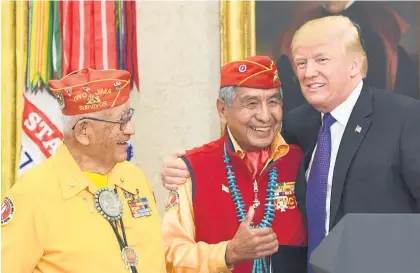 ?? Pictures / AP ?? Navajo “code talkers” (from left) Thomas Begay and Peter MacDonald meet Donald Trump yesterday.