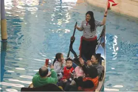  ??  ?? GONDOLIER June Gonzaga entertains her passengers with a song.