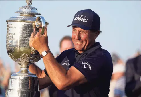  ?? David J. Phillip / Associated Press ?? Phil Mickelson holds the Wanamaker Trophy after winning the PGA Championsh­ip at the Ocean Course on May 23 in Kiawah Island, S.C. Mickelson committed to the Travelers Championsh­ip on Thursday.