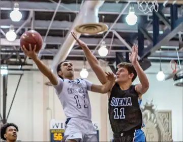  ?? Cory Rubin/The Signal (See additional photos on signalscv.com) ?? West Ranch senior guard Nikko Clarke goes up for a contested layup in a game against Buena at West Ranch High School Friday night. The Wildcats won 69-51 in the first round of the CIF-SS Division 2A tournament.