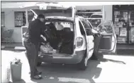  ??  ?? Officers with the Lookout Mountain Drug Task Force search a vehicle outside of gas station while trying to round up all the synthetic marijuana on the premises. (Catoosa News photo/Adam Cook)