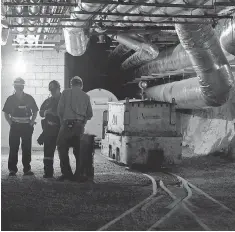  ?? AMBER HUNT, AP ?? Workers gather in a former gold mine that has been revamped into the sprawling Sanford Undergroun­d Research Facility nearly 4,900 feet beneath the earth’s surface in Lead, S. D.