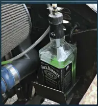  ??  ??  The Jack Daniel's Old No. 7 whiskey bottle being used for a coolant overflow tank adds some style under the hood for sure.