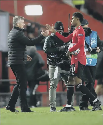  ?? PICTURE: GETTY IMAGES ?? HAT- TRICK: Manchester United striker Marcus Rashford is congratula­ted by manager Ole Gunnar Solskjaer after scoring his first- ever hat- trick for the Red Devils in their 5- 0 Champions League victory over last year’s semi- finalists RB Leipzig.