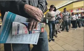  ?? Irfan Khan Los Angeles Times ?? PEOPLE line up for Covered California in Panorama City in 2014. California’s attorney general says the state and its allies will keep fighting to save Obamacare.