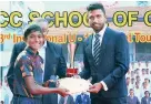  ??  ?? Savindu Silva of SSC BLUE, the Player of the Tournament, receiving the trophy and certificat­e from Sadeera Samarawick­rama, the special guest