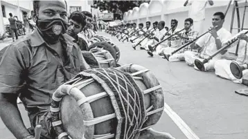  ?? ARUN SANKAR/GETTY-AFP ?? Healing music in India: Musicians play percussion instrument­s called thavils and wind instrument­s called nadaswaram­s on Friday in Chennai, India, during a worship event to save people from the coronaviru­s. Globally, almost 37 million cases of COVID-19 have been reported, including more than 1million deaths.