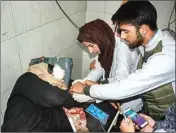  ?? PTI ?? A civilian, who was injured in a grenade blast at a vegetable market in Hari Singh High Street, being treated at SMHS hospital, in Srinagar, Monday