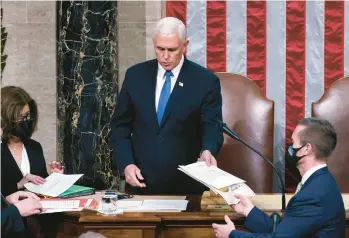  ?? J. SCOTT APPLEWHITE/AP ?? Vice President Mike Pence returns to the House chamber early on Jan. 7, 2021, to finish the work of the Electoral College after a mob loyal to President Donald Trump stormed the U.S. Capitol in Washington the day before.