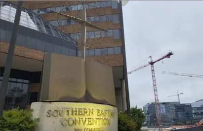  ?? Holly Meyer/Associated Press ?? A cross and Bible sculpture stand outside the Southern Baptist Convention headquarte­rs on Tuesday in Nashville, Tenn. A report released this week detailed how leaders in the church covered up widespread sexual abuse for decades.