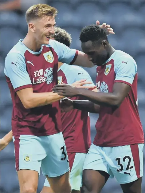  ??  ?? Dunne (left) playing for parent club Burnley.