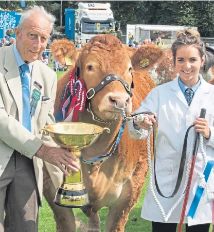  ?? Pictures: Angus Findlay. ?? Stephanie Dick, with Limousin heifer Stephick Mistique, is presented with Perth Show’s Angus Howie Trophy, for the event’s champion of champions, by David Armstrong.