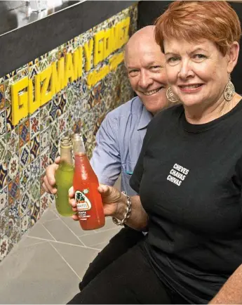  ?? Photo: Nev Madsen ?? MUCHOS GRACIAS: Owners Randall North and Judy Moore toast to the opening of their Guzman y Gomez in Toowoomba in March 2015. They are selling up to move into retirement.
