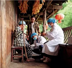  ?? ?? Village doctors treat villagers of the Miao ethnic group in southeaste­rn Guizhou Province on August 17, 2021