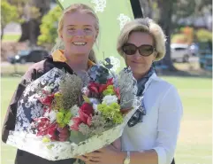  ??  ?? DSG Athletics Captain for 2016, Hannah Rippon presents the guest of honour, Wendy Rippon (her mother) with flowers at the prize giving at the end of another successful inter-house sports day held on Lower Field, SAC on 13 October. Chiara Williams-Wynn,...