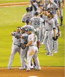  ?? David Santiago / Miami Herald ?? American League players, including game MVP Robinson Cano (front, center) celebrate their team’s 2-1 victory in Miami.