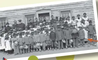  ??  ?? Children and school officials outside the Fort Providence residentia­l school in the Northwest Territorie­s around 1920.