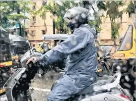  ?? Shashank Bengali Los Angeles Times ?? A MOTORCYCLE rider is dressed for the monsoon in Mumbai, India.