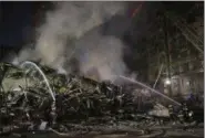  ?? ANDRE PENNER — THE ASSOCIATED PRESS ?? Firefighte­rs work in the rubble of a building that caught fire and collapsed in Sao Paulo, Brazil, Tuesday. The abandoned high rise building occupied by squatters caught fire and collapsed sending chunks of fiery debris crashing into neighborin­g...