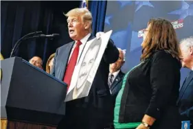  ?? AP PHOTO BY EVAN VUCCI ?? President Donald Trump speaks Friday about immigratio­n alongside family members affected by crime committed by undocument­ed immigrants, at the South Court Auditorium on the White House.