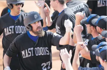  ?? KAYLE NEIS ?? East Hants Shooters Bar & Grill Mastodons’ Nick Shailes celebrates with his Nova Scotia team after a home run during the Canadian men’s fastpitch championsh­ip Sunday at Bob Van Impe Field in Saskatoon.