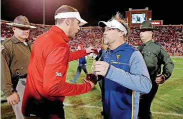  ?? [PHOTO BY BRYAN TERRY, THE OKLAHOMAN] ?? Oklahoma coach Lincoln Riley and West Virginia coach Dana Holgorsen shake hands after last season’s game in Norman. OU won the game, 59-31.