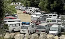  ??  ?? Overcrowdi­ng and a lack of facilities at freedom camping sites like the one at Waitapu Bridge have raised health concerns, but the Tasman District Council has no plans to close them.